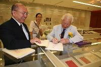 Mr. T.C. Lai signing the book